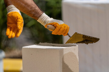 The bricklayer is working. Building a wall of aerated concrete. Gasbeton wall