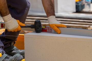 The bricklayer is working. Building a wall of aerated concrete. Gasbeton wall