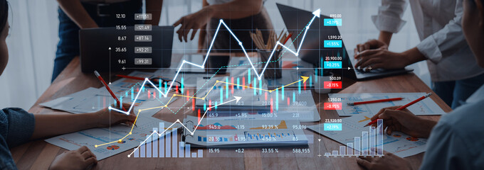 A dynamic workspace featuring a collaborative team analyzing business trends through charts and graphs, demonstrating growth and strategic planning in finance. Scalp