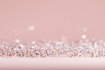 Background Close-up of Sparkling Confetti on a Pink