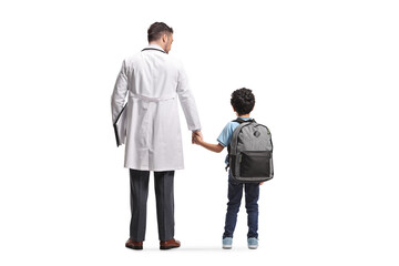 Doctor standing and holding hands with a schoolboy
