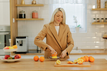 Woman making fresh orange juice