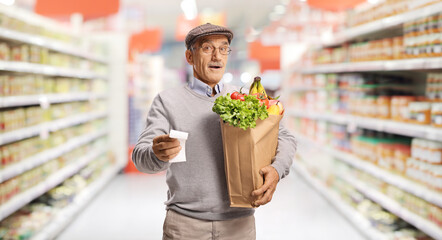Elderly man with groceries and receipt