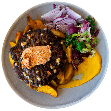 Traditional Macedonian dish pleskavica, which has become popular strip food in central Europe. Pleskavitsa is chopped cutlet cooked on grill. Isolated over white background