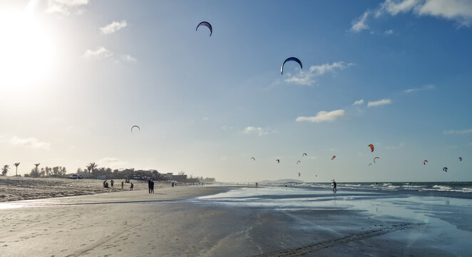 Golden hour at Prea beach with kitesurfers enjoying in the ocean.