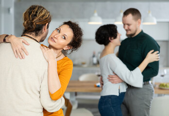 Friends dancing. Cheerful young people dancing and drinking while enjoying home party on the room