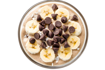 Banana Nice Cream rozen bananas blended into a creamy dessert topped with chocolate chips and coconut flakes top view isolated on white background.jpeg