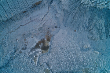 Abstract grey industrial ash texture with water erosion channels, dendritic drainage pattern, aerial drone shot top view, neural network concept