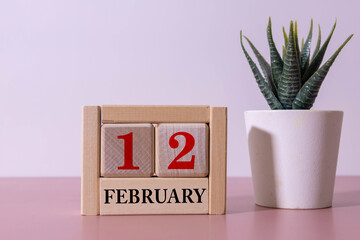 calendar displaying FEBRUARY 12 with light grey background.