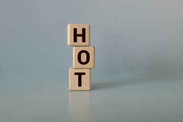 Too Hot, words in wooden alphabet letters in crossword form isolated on background.