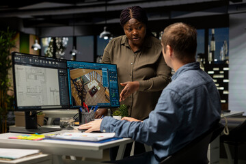 Diverse engineers team creates 3D render of apartment interior with an architectural software and blueprints. Using computer with modern tools and models to allow customization of flooring.