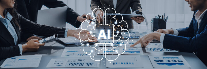 Professionals engage in a collaborative meeting, utilizing artificial intelligence and data analysis tools to strategize and enhance business performance in a modern office setting. Trope