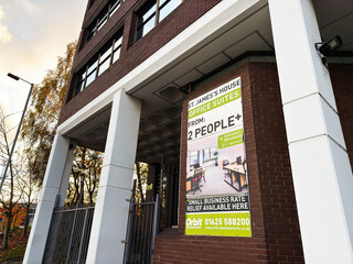 Naklejka premium Office building sign advertising office suites in Salford UK for two people