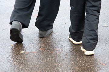 Fragments of the legs of people walking on the pavement