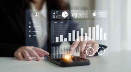 A business professional interacts with a smartphone displaying a digital dashboard filled with data and statistics in a modern office environment. Impute