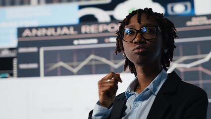 Close up of management executive comparing company metrics on digital videowall before making...