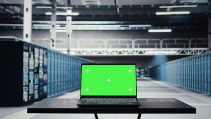 Isolated screen laptop in data center used for doing maintenance on infrastructure, improving workload. Chroma key notebook in server farm used by high tech server clusters for parallel processing