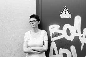 Thoughtful businesswoman looking away while standing in urban environment