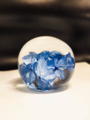 epoxy resin ball with flowers on a blurred background