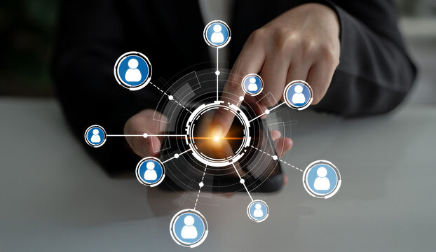 A business professional interacts with a smartphone displaying a digital network of people icons, illustrating modern interactions and technology engagement trends. Crux - Powered by Adobe