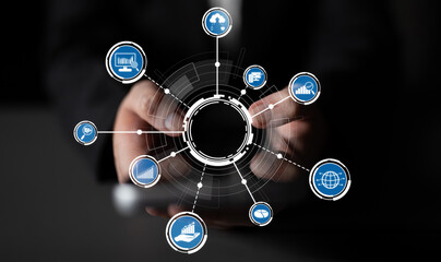 A close-up of hands presenting a digital interface filled with various business icons. This image symbolizes technology, analytics, and global connectivity in a modern business environment. Crux