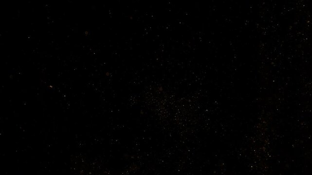 Super Slow Motion Shot of Golden Glitters on Black Background at 1000fps.