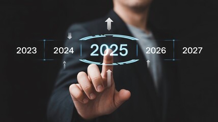 Businessman touching futuristic interface with 2025 highlighted in blue glow on dark background for corporate technology