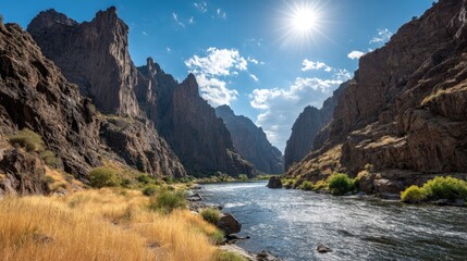 Serene River Flowing Through Majestic Mountains Under Bright Sunlight and Blue Sky
