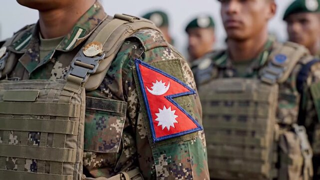 Military personnel wearing camouflage uniforms with Nepalese flags in