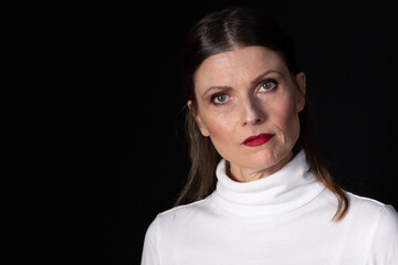 Woman facing camera with strong expression in studio portrait
