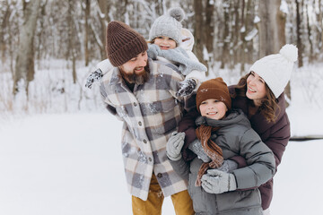 Fototapeta premium Family enjoying winter day playing outdoors in snow