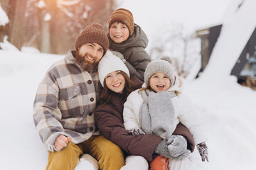 Happy family enjoying winter vacation together in snow