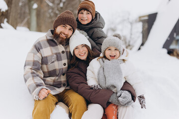 Family enjoying winter vacation together in snow