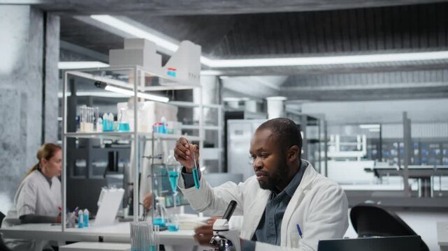 Lab assay development specialist investigating blue liquid polymer properties in test tube container. Molecular biologist testing new synthetic material durability and viscosity in lab, camera A