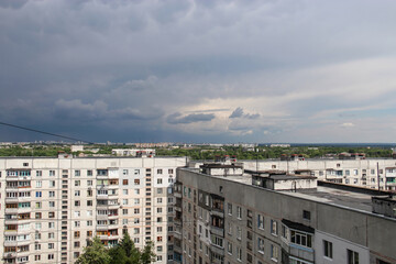 A panoramic urban view of a residential district in Kharkiv, Ukraine, featuring typical multi-story concrete apartment blocks.