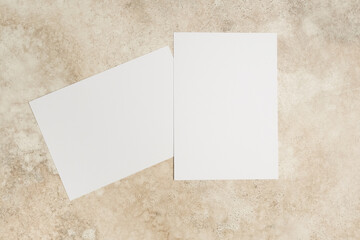 Blank invitation card mockup on textured surface, showcasing two cards with ample copy space for customizable designs and creative concepts for various occasions