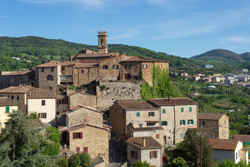 Obraz premium Panoramic view of the village of Montecerboli in Tuscany, Italy, a historic stone village on a hillside