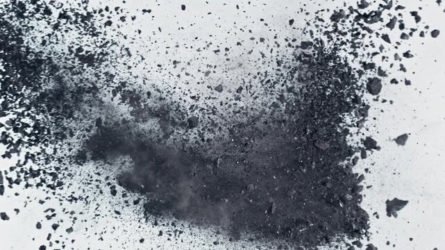 Super Slow Motion Flying and Colliding Crushed Coal Isolated On White Background at 1000 fps.