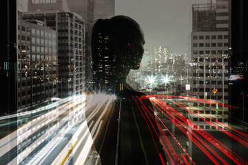 A thinking businesswoman looks out over the city skyline at. Female silhouette facing City, people reaching goals, having a future vision concept 