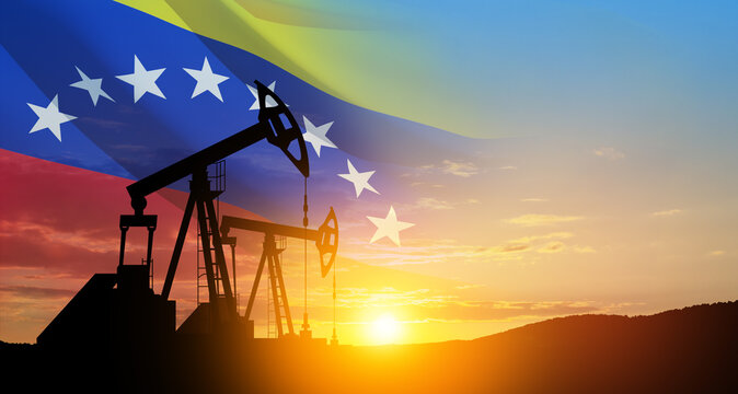 The change in oil prices. Oil price cap concept. Oil drilling derricks at desert oilfield with Venezuela flag. Crude oil production from the ground. Petroleum production.
