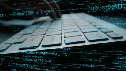 A close view of hands on a computer keyboard creating code, surrounded by data elements, representing the digital workspace and coding process. Perfect for tech themes. Xenic