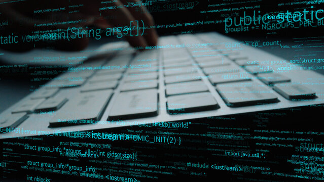 A close view of hands on a computer keyboard creating code, surrounded by data elements, representing the digital workspace and coding process. Perfect for tech themes. Xenic