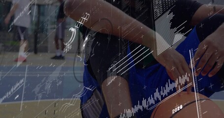 Dribbling player crouching handling ball on court in blue shorts knee sleeve ring data overlays