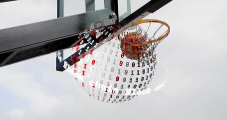 Basketball moving through orange rim and white net at outdoor backboard, with binary digits