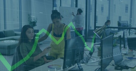 Pointing coworkers in yellow overalls using monitor with green graph overlay in office, copy space