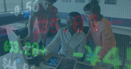 Reviewing seated man in light grey jacket using monitor and tablet at office with data overlay