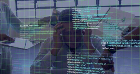 Leaning man and colleagues in blazers taking notes at conference table with notepad, code overlay