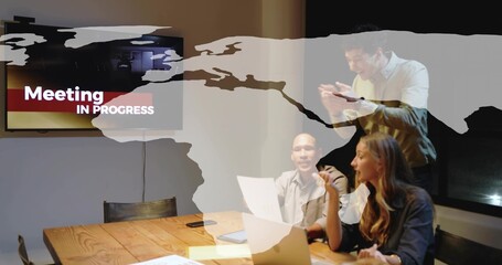 Talking team presenting in meeting room in suits with laptop display showing Meeting IN PROGRESS