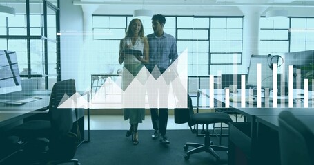 Walking colleagues navigating open office in business wear, holding tablet with data graph overlay