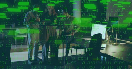 Discussing three coworkers in business-casual reviewing monitors in open office, binary overlay